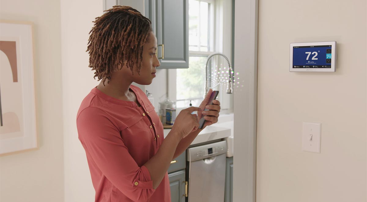 American Standard Woman looking at thermostat